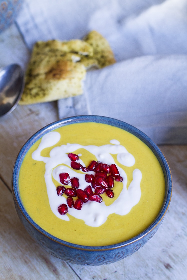 Soup with ginger cream and pomegranate arils as toppings.