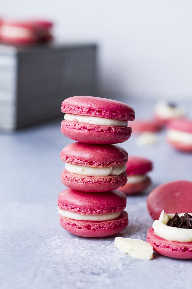 Three pink macarons stacked on top of each other.