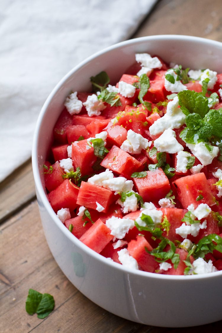 Watermelon salad, feta cheese and mint in a white bowl.