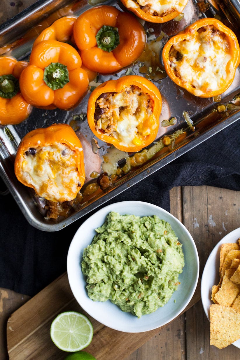 Stuffed peppers with melted cheese in a metal pan. Flatlay.