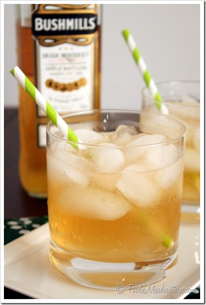 Irish Maiden Whiskey cocktail in a rock glass with ice cubes and green straw.