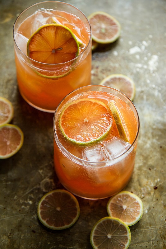 Grapefruit whiskey sour in rocks glasses with citrus garnish.