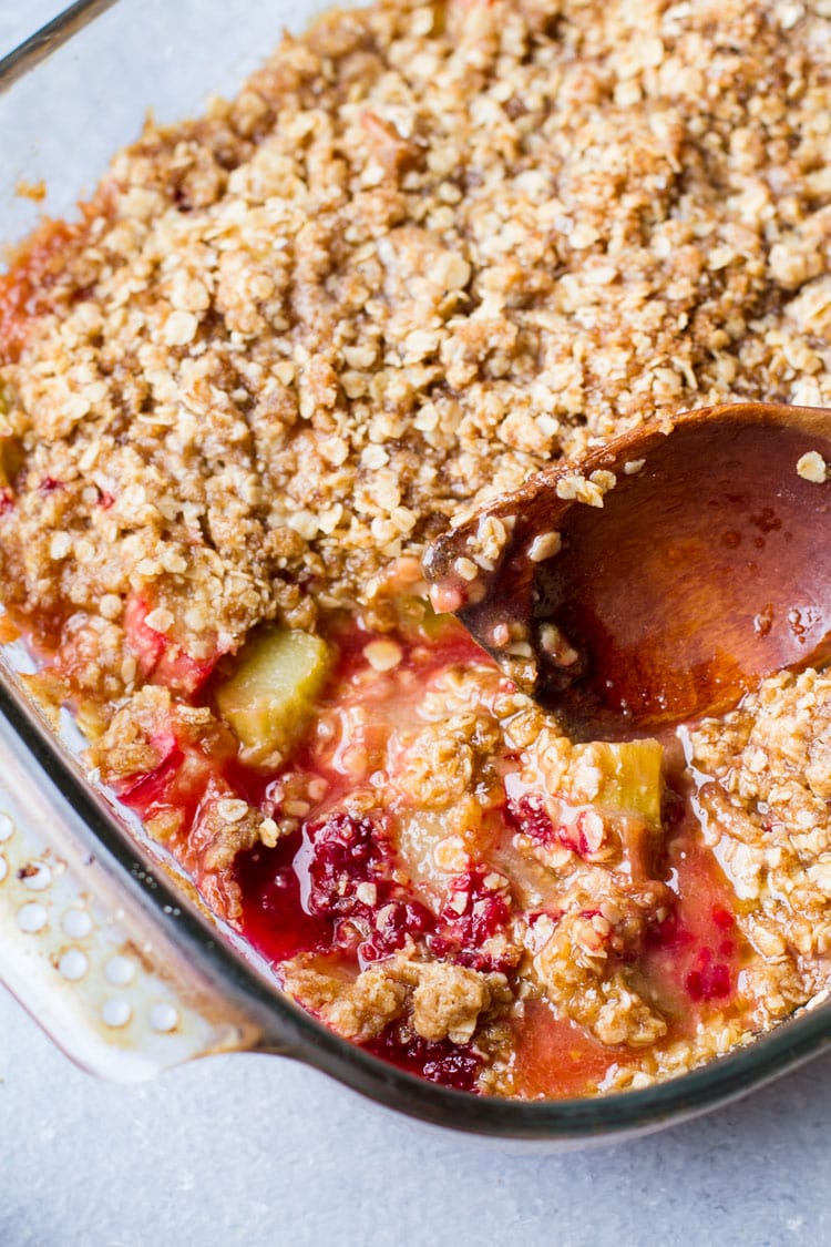 Closeup of the rhubarb crisp and a wooden spoon.
