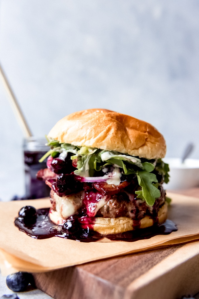 Burger with blueberry compote running down the side.