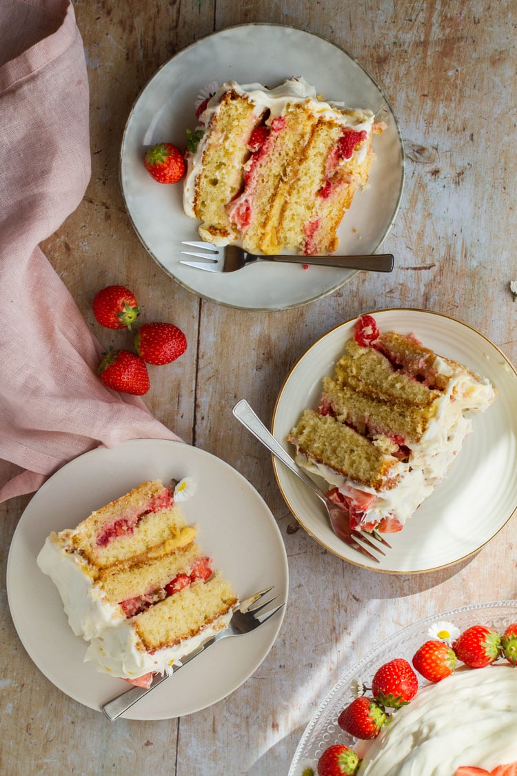 Three slices of strawberry and lemon curd cake. Flatlay.