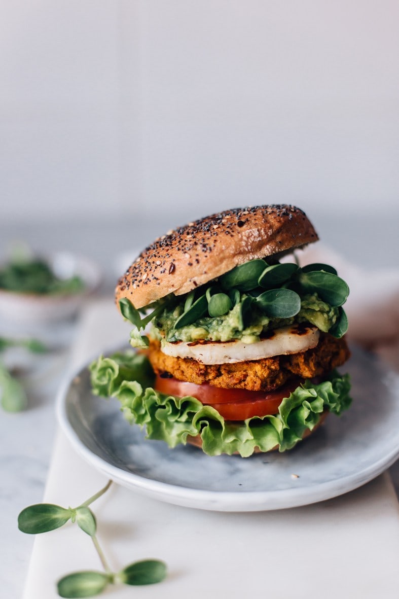 Sweet potato burger with a lot of green vegetables and healthier burger bun.