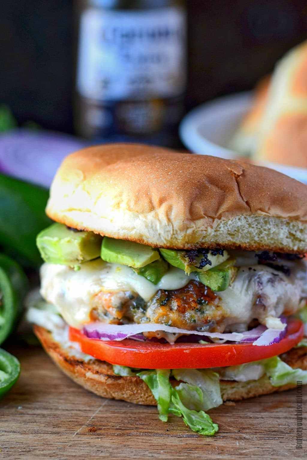 Chicken burger with avocado and tomato.