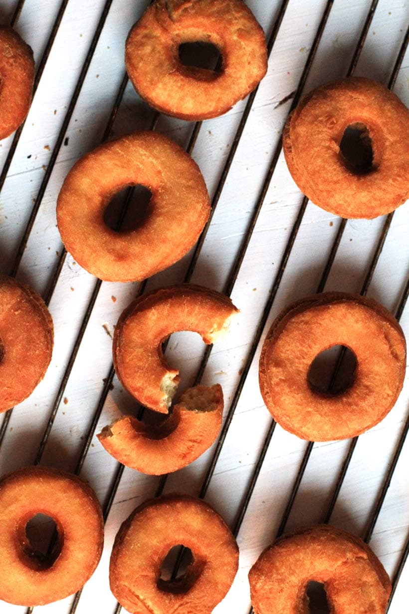 Donuts, unglazed on a cooling rack.