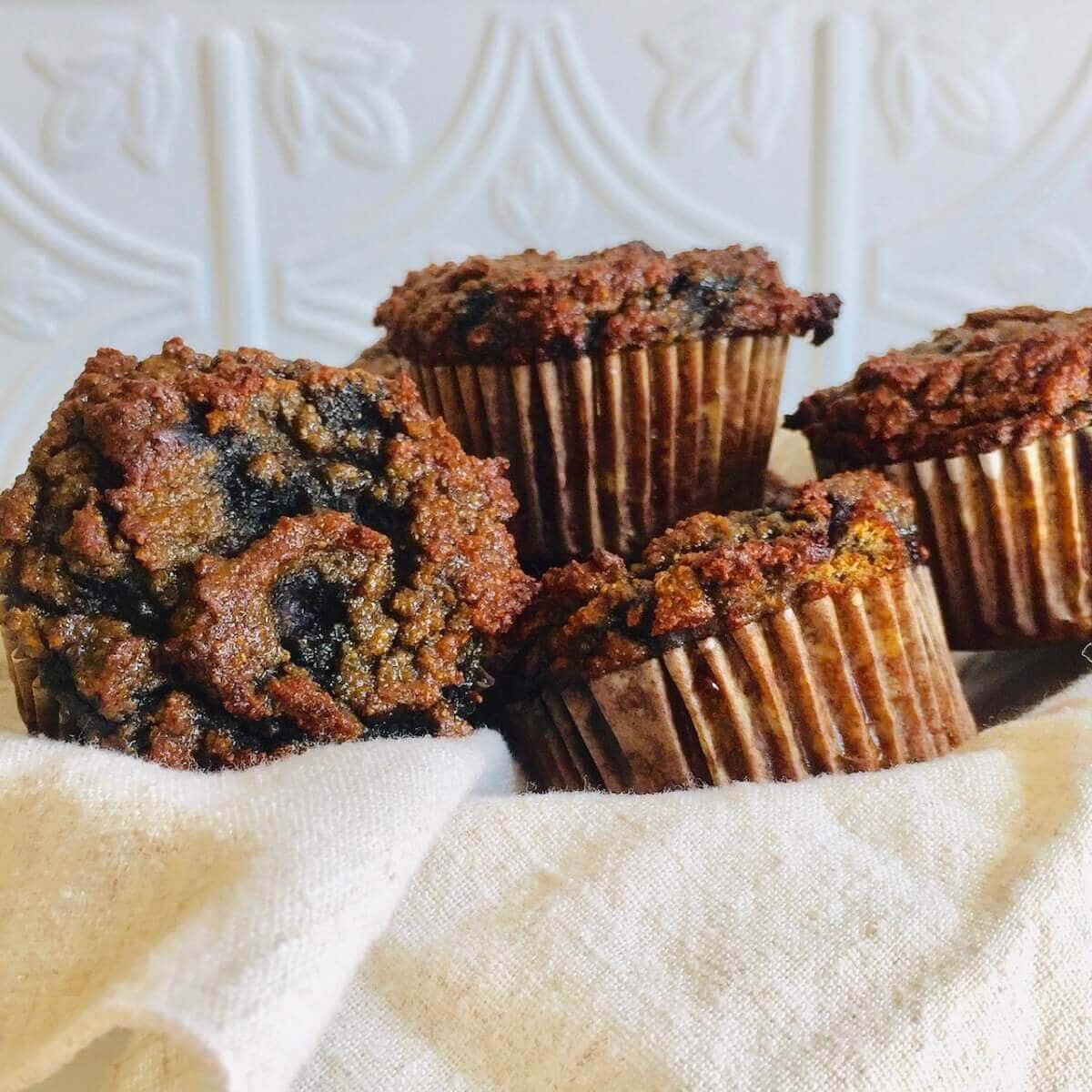 Healthy Blueberry Muffins in a light colored towel.