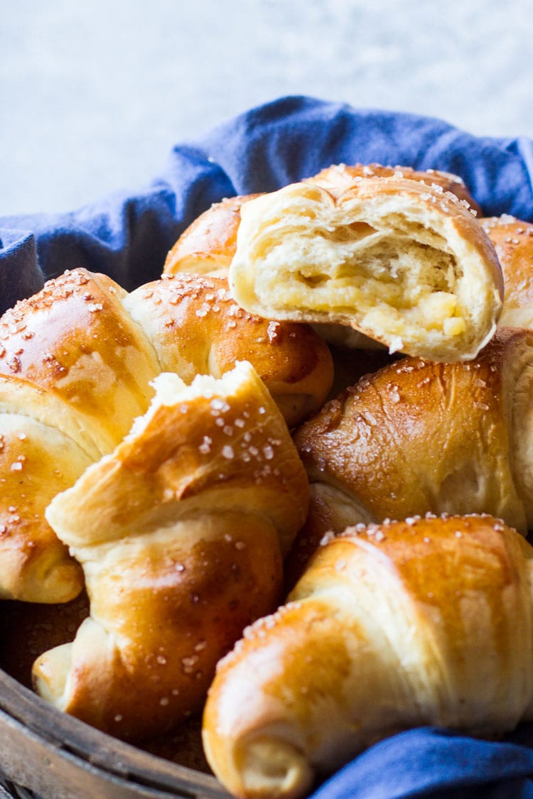 Close-up of a basket with homemade rolls filled with vanilla custard.