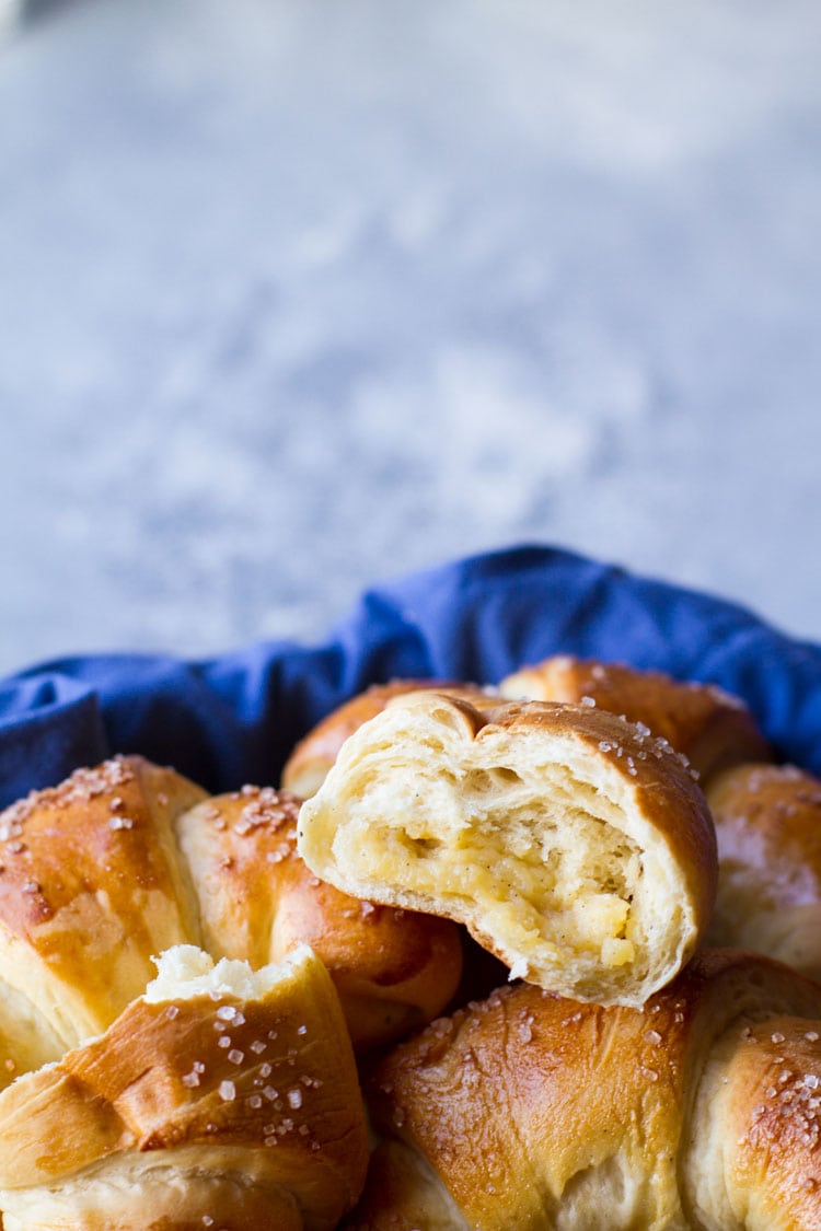 Close up of one open crescent roll filled with vanilla custard.