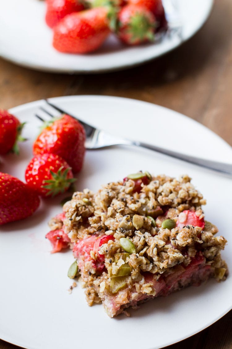 Strawberry rhubarb oatmeal square on a white plate.