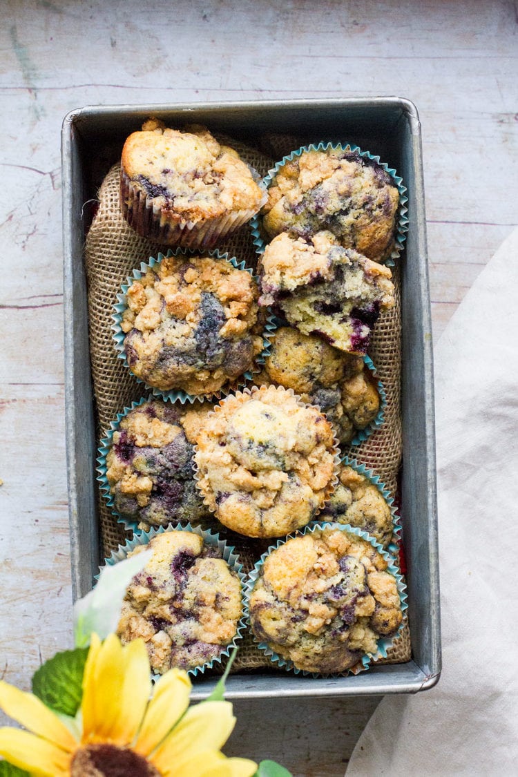 Blueberry muffins in a rectangular metal box.