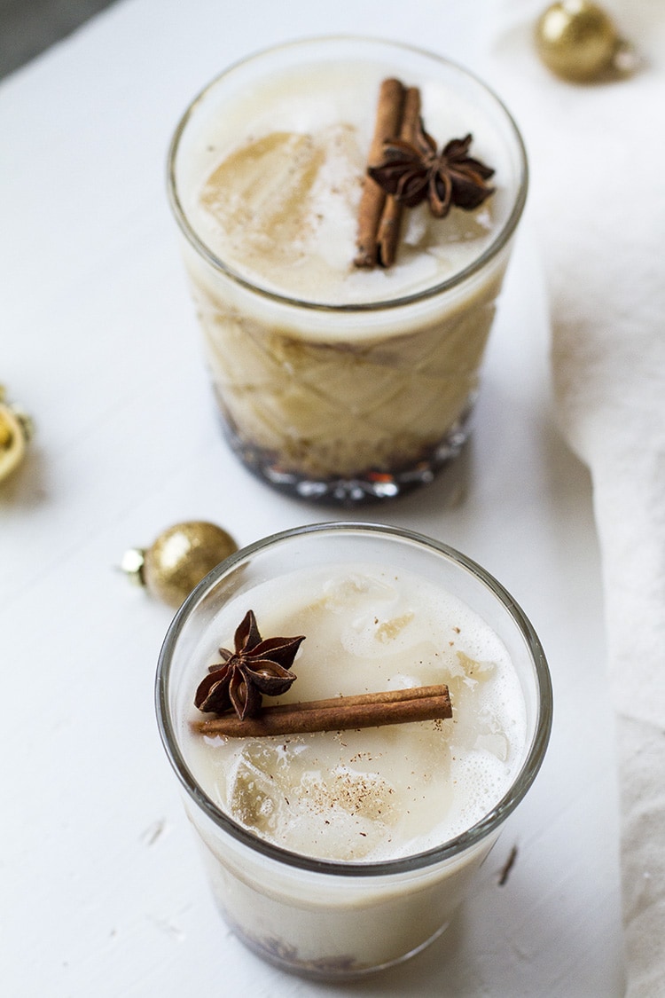 Eggnog white russian garnished with cinnamon stick and star anise.